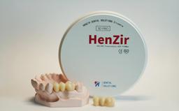 HenZir 3D PRO multilayer zirconia disc beside a dental model