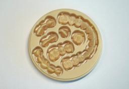 Zirconia disc filled with crowns and bridges cut from the blank